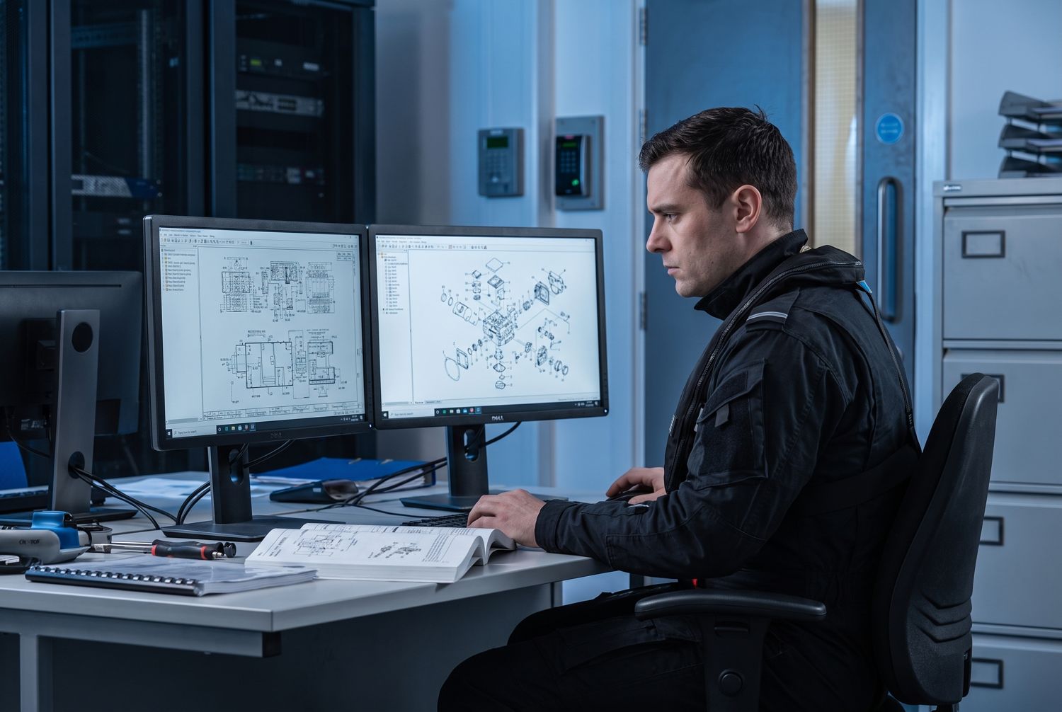 Defense technical documentation specialist reviewing military technical manuals